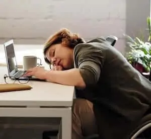 tired woman on table taking nap