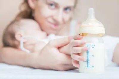 baby touches bottle