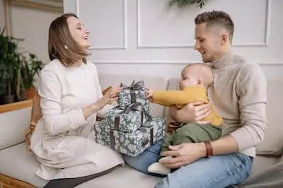 baby and parents with gifts