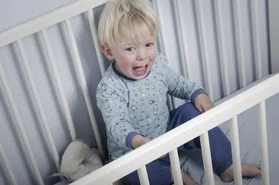 baby on crib crying at night