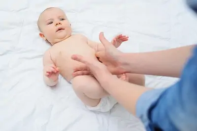 mom helping baby to relieve gas