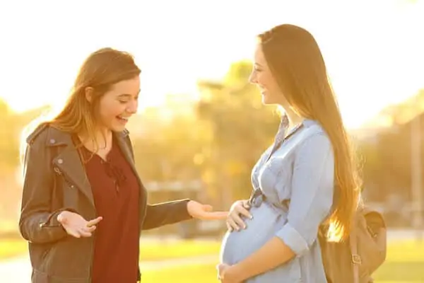 surprised friend seeing pregnant friend