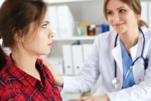 Female doctor touching patient shoulder for encourage