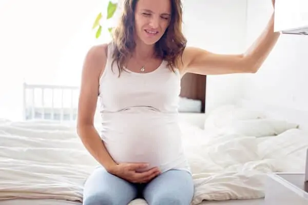 woman in pregnancy feeling the pain