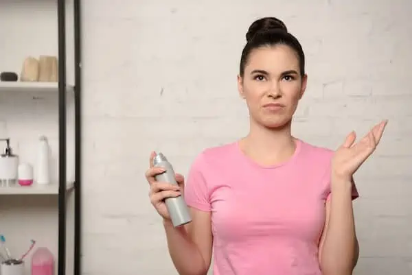 woman with deodorant in hand