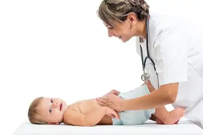 female doc checking up baby stomach