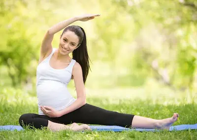 pregnant woman outdoor stretch fitness goal