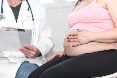 doc checking pregnant woman