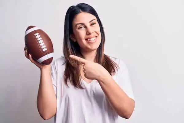 woman holds a rugby ball