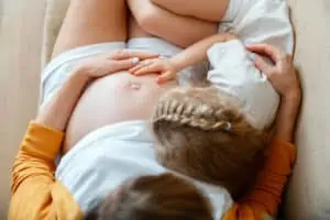 toddler hugs pregnant belly