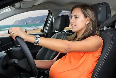 pregnant woman behind the steering wheel