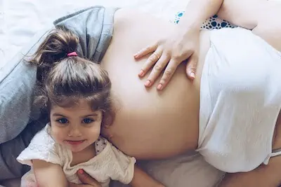 Beautiful pregnant woman and her cute little