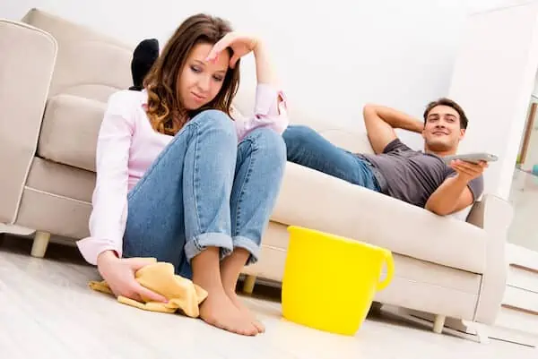 mom cleans while dad lying on sofa