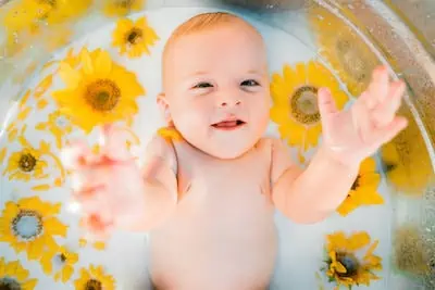 cute baby enjoys milk bath