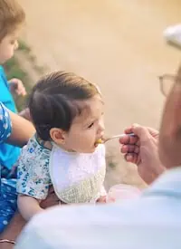 senior feeding puree to a girl