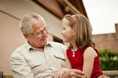 grand daughter telling something to grandfather