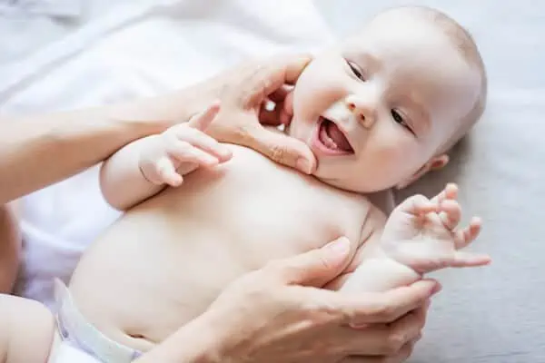 mother checking baby first teeth
