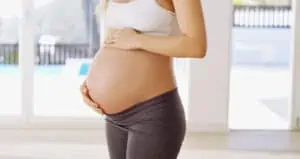 woman rubs pregnant belly