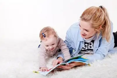 baby busy reading books with mom