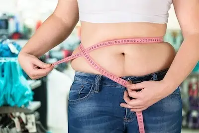 fat woman wears jeans and muffin top