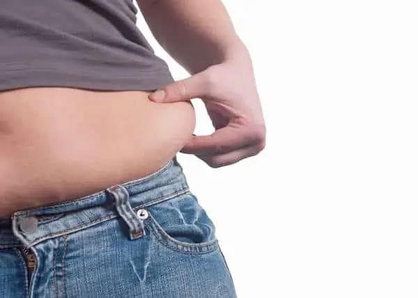 woman touching her love handles