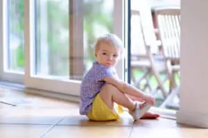 baby girl sits on floor