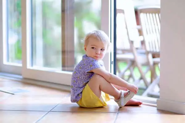 baby girl sits on floor