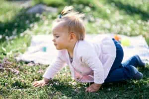 ponytailed little girl crawling
