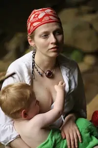mom breastfeeds her child