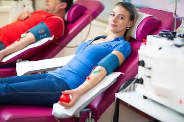 Young woman giving blood in a modern hospital