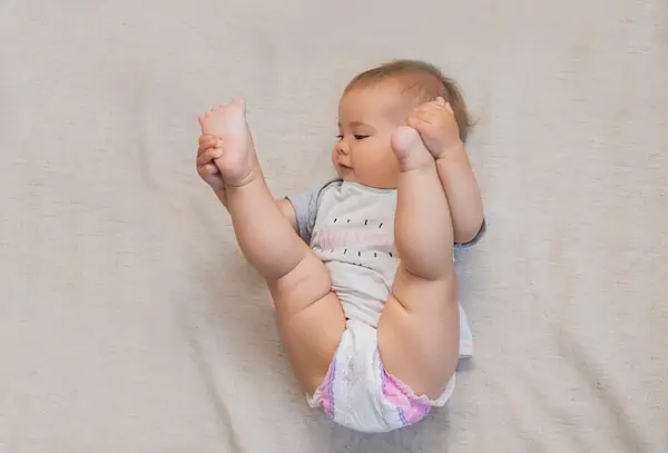 baby lying on floor looking upward