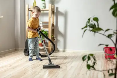 a child using vacuum machine