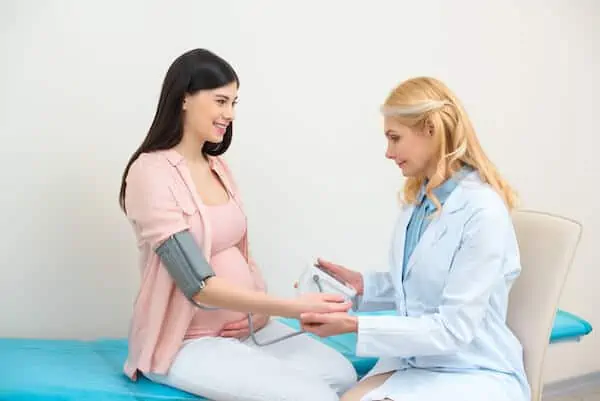 Pregnant woman's BP checked by doctor