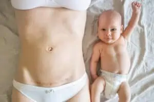 baby by side of mom with c-section scar