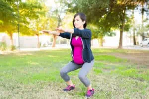 Pregnant woman with an active lifestyle doing squats
