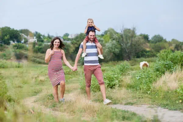 pregnant woman walking happily with family