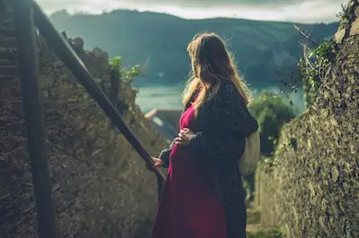 pregnant woman climbing stairs